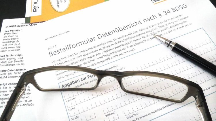 Brille und Stift auf Formular